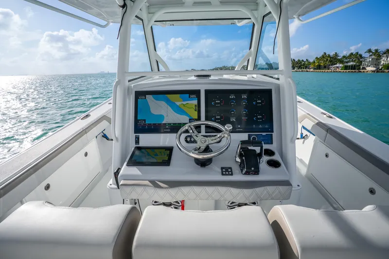 Slide: The Image of 2024 Yellowfin 39 Offshore boat cockpit with advanced navigation system on open water. - 16