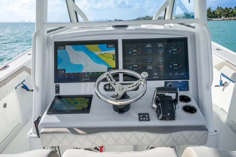 Slide: The Image of 2024 Yellowfin 39 Offshore boat dashboard with advanced navigation displays and controls. - 17