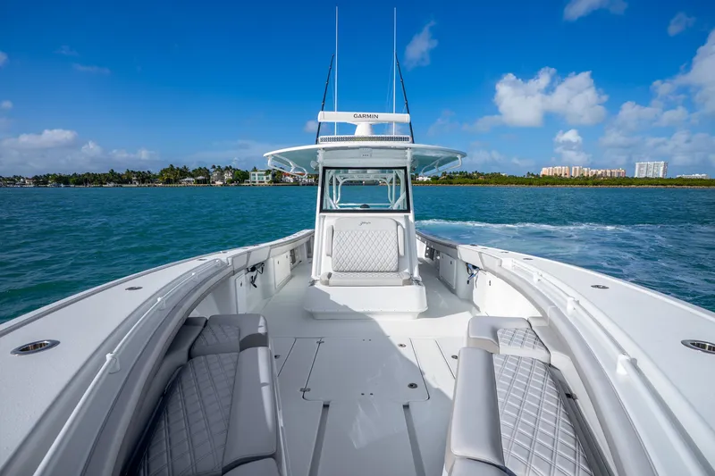Slide: The Image of 2024 Yellowfin 39 Offshore boat cruising on blue ocean under clear sky. - 24