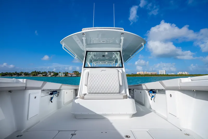 Slide: The Image of 2024 Yellowfin 39 Offshore boat on clear blue water under a sunny sky. - 26