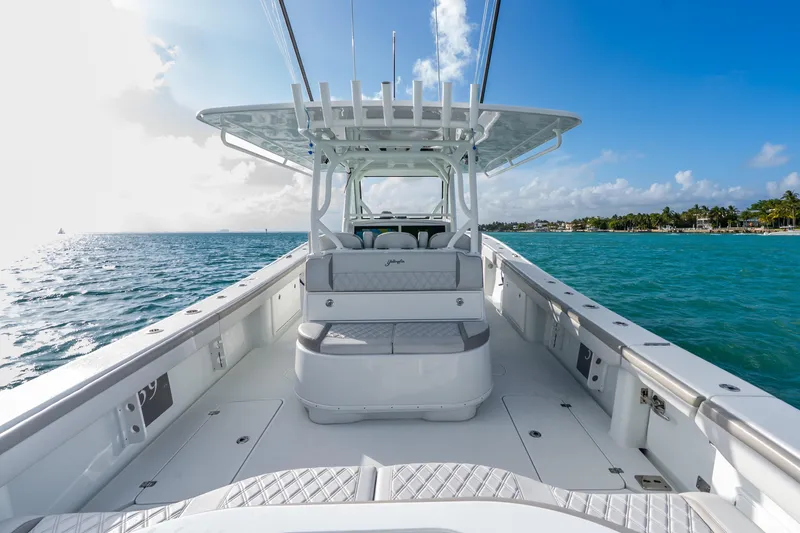 Slide: The Image of 2024 Yellowfin 39 Offshore boat on clear blue water, sunny day, spacious deck. - 30