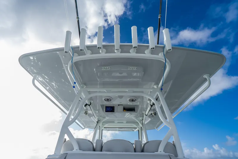 Slide: The Image of 2024 Yellowfin 39 Offshore boat with sleek design against a bright blue sky. - 32