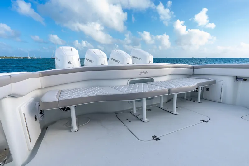 Slide: The Image of 2024 Yellowfin 39 Offshore boat with cushioned seating and Mercury engines, ocean backdrop. - 33