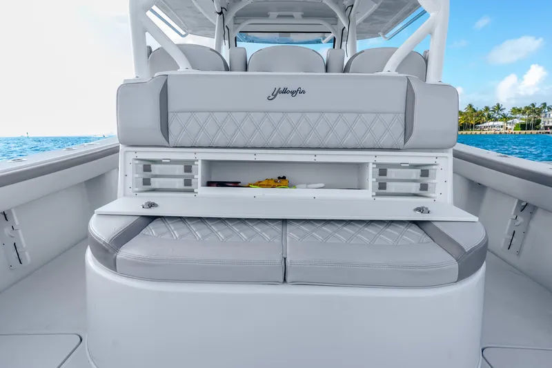 Slide: The Image of 2024 Yellowfin 39 Offshore boat interior with storage compartments and cushioned seating. - 34