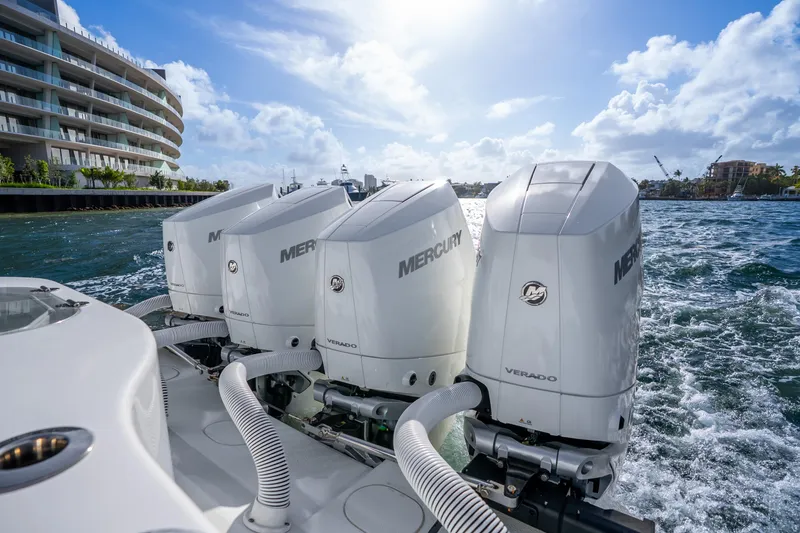 Slide: The Image of 2024 Yellowfin 39 Offshore boat with Mercury Verado engines cruising near waterfront buildings. - 39