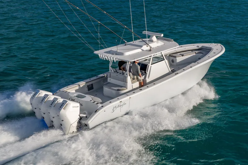 Slide: The Image of 2024 Yellowfin 39 Offshore boat cruising on open water, showcasing powerful engines. - 4