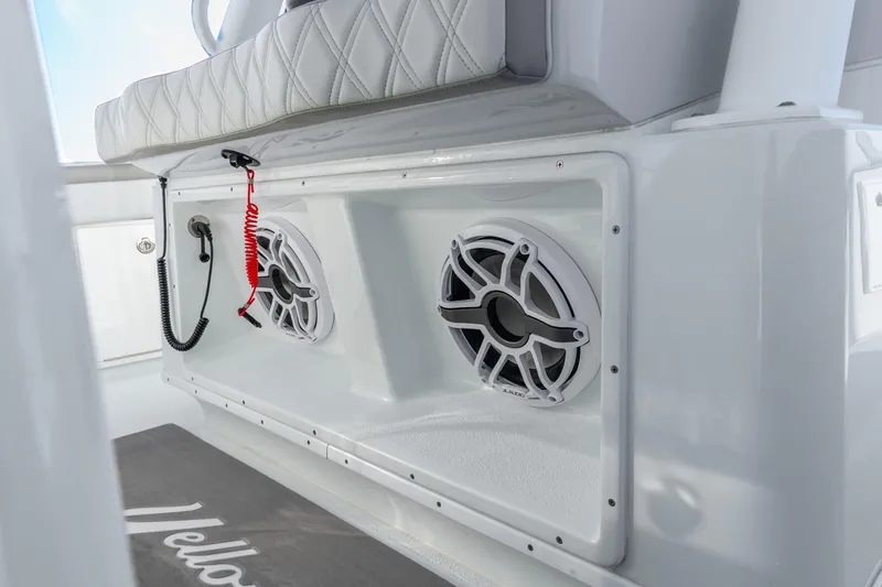 Slide: The Image of 2024 Yellowfin 39 Offshore boat interior with speakers and cushioned seating. - 42