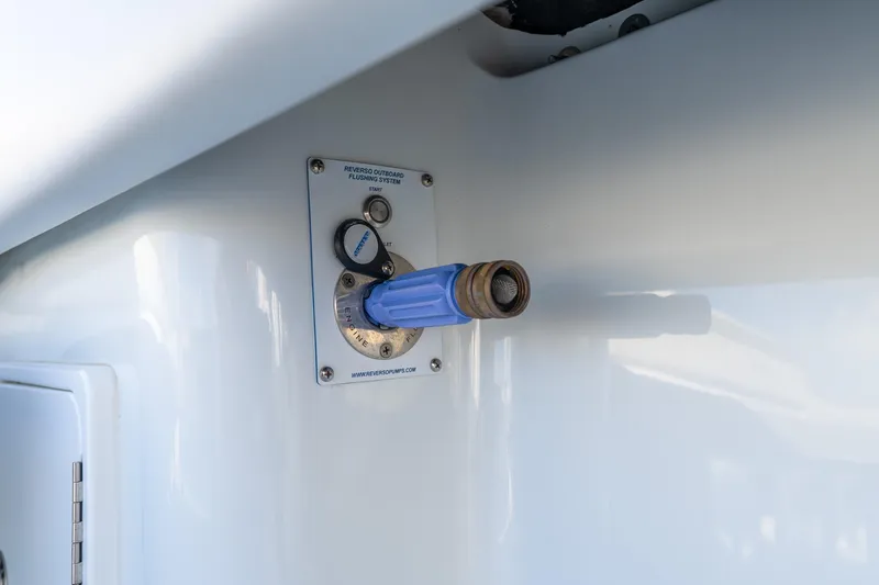 Slide: The Image of 2024 Yellowfin 39 Offshore boat's Reverso outboard flushing system with blue hose attachment. - 45