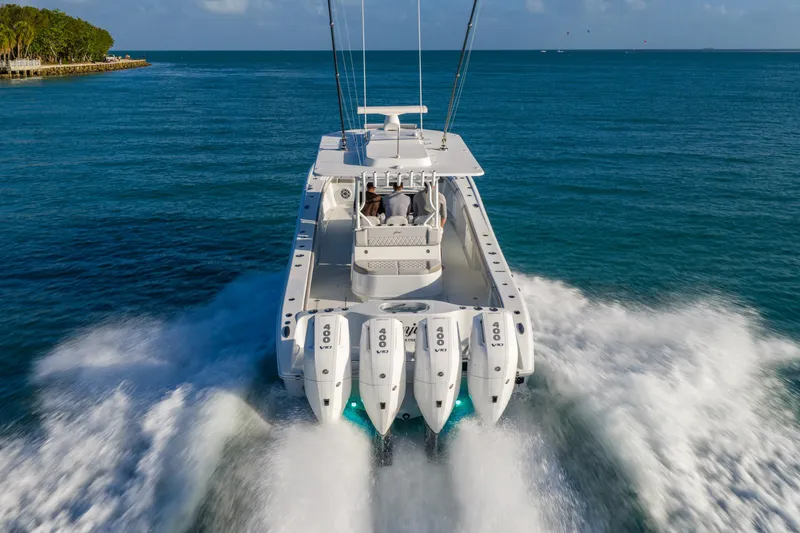 Slide: The Image of 2024 Yellowfin 39 Offshore boat cruising on open water with four powerful engines. - 7