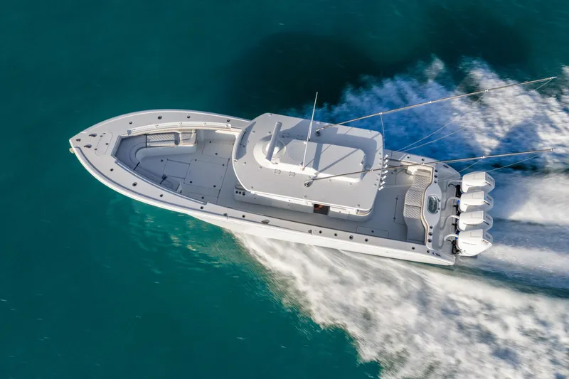 Slide: The Image of 2024 Yellowfin 39 Offshore boat cruising on clear blue water, aerial view. - 9