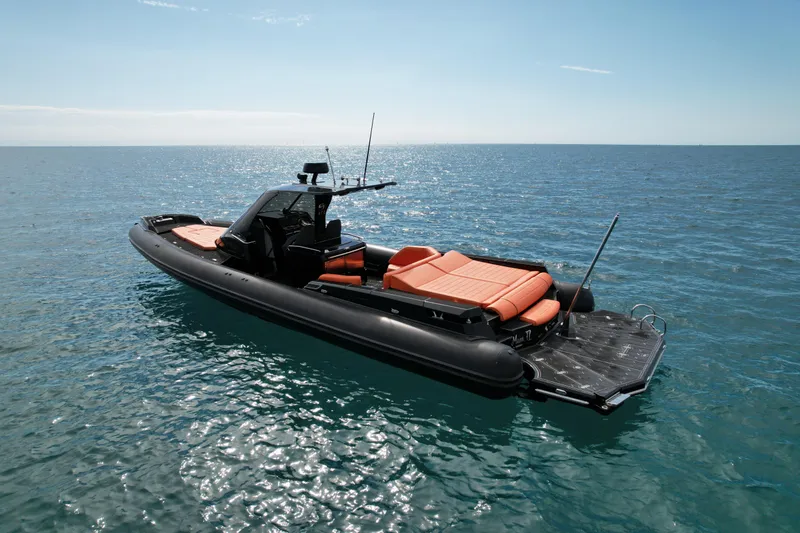 The Image of 2017 MV Marine 40 boat with orange seating on calm ocean waters. - 0