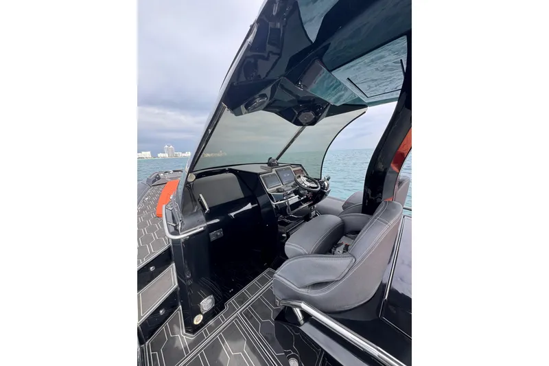 Slide: The Image of Cockpit view of 2017 MV Marine 40 boat with modern controls and ocean backdrop. - 10