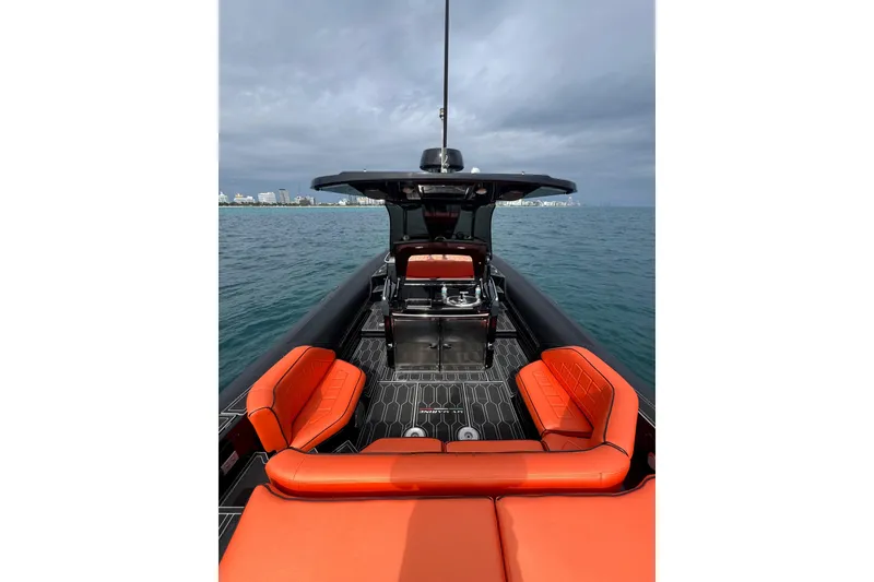 Slide: The Image of 2017 MV Marine 40 boat with orange seating, sleek design, and ocean backdrop. - 12