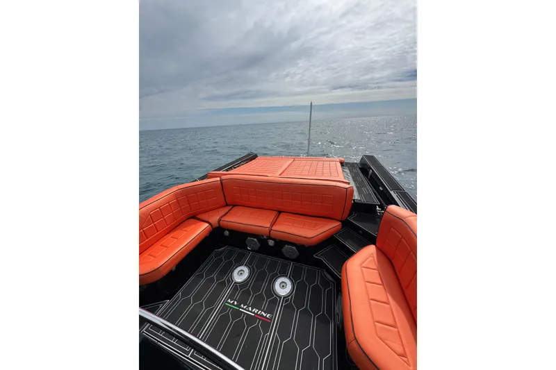 Slide: The Image of MV Marine 40 boat, 2017 model, with orange seating, on open water under cloudy sky. - 14