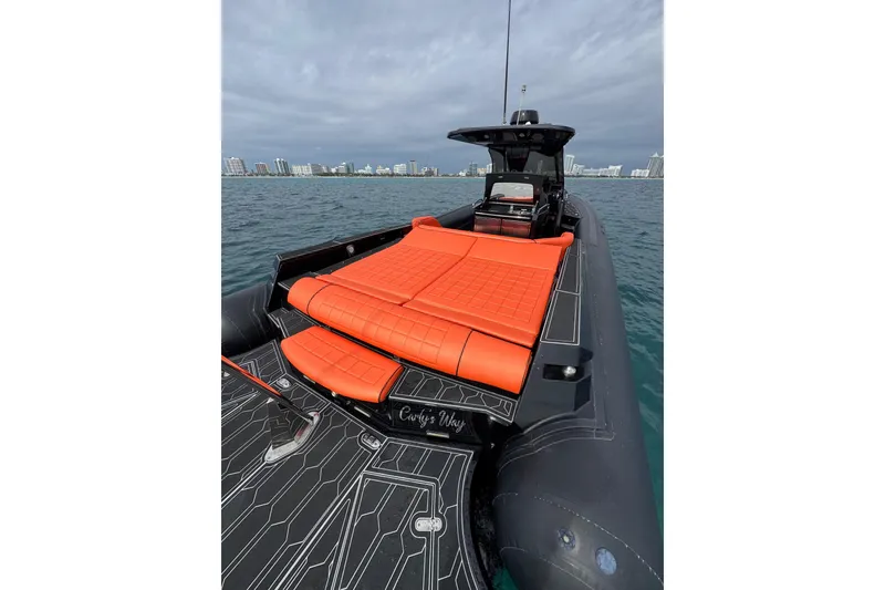 Slide: The Image of 2017 MV Marine 40 boat with orange seating, on water near city skyline. - 16