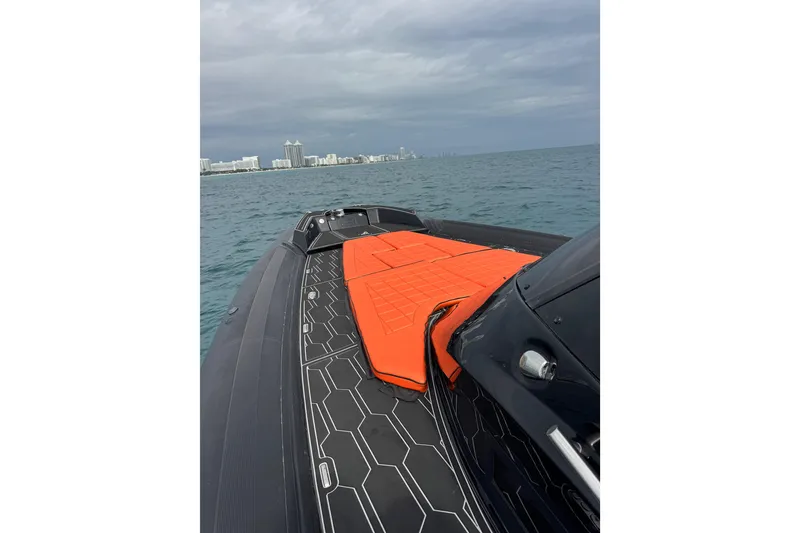 Slide: The Image of 2017 MV Marine 40 boat with orange deck cushions on open water. - 19