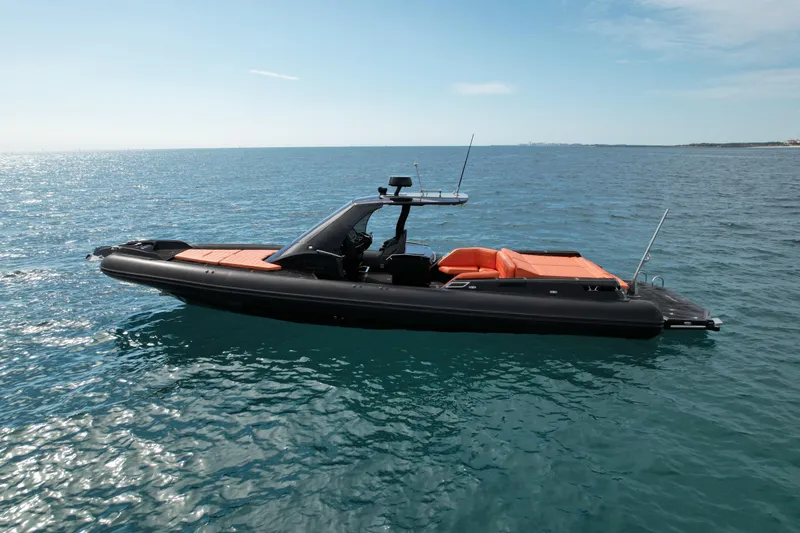 Slide: The Image of 2017 MV Marine 40 boat with orange seating, floating on calm blue sea. - 2