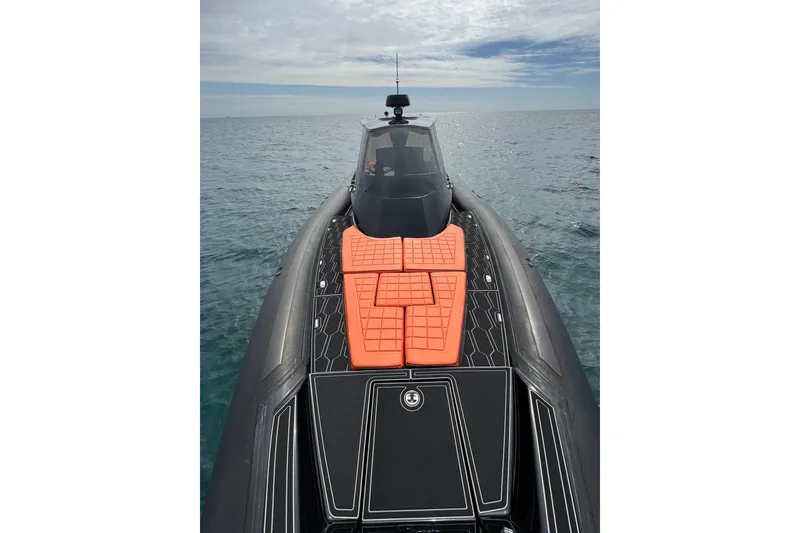 Slide: The Image of 2017 MV Marine 40 boat with orange seating, cruising on open water under cloudy skies. - 20