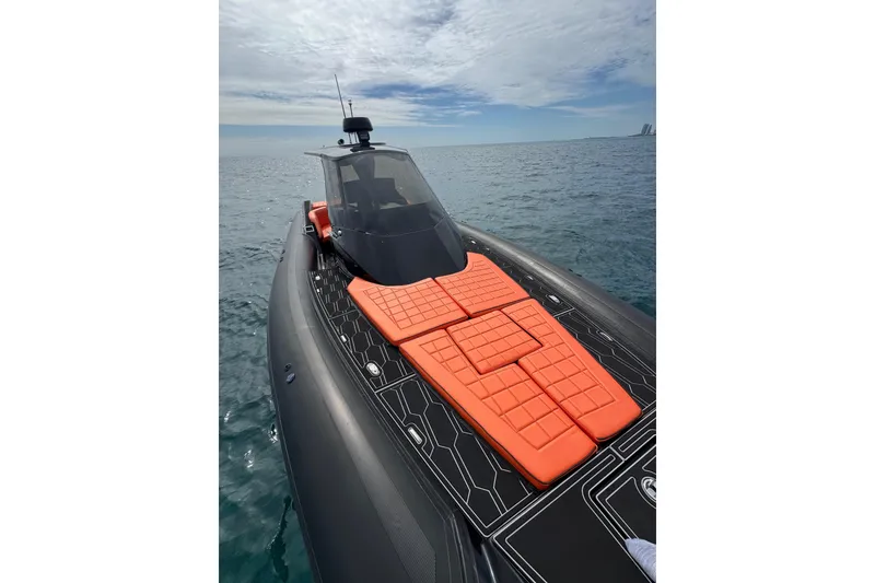 Slide: The Image of 2017 MV Marine 40 boat with orange deck cushions on open water. - 23