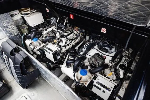 Slide: The Image of Engine compartment of a 2017 MV Marine 40 boat, showcasing dual engines and components. - 26