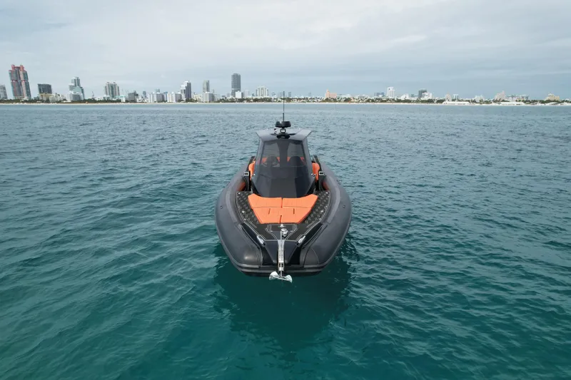 Slide: The Image of MV Marine 40 boat on open water, city skyline in background, 2017 model. - 3