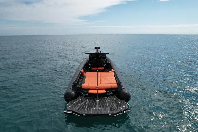 Slide: The Image of MV Marine 40 boat, 2017 model, with orange seating, floating on calm ocean waters. - 7