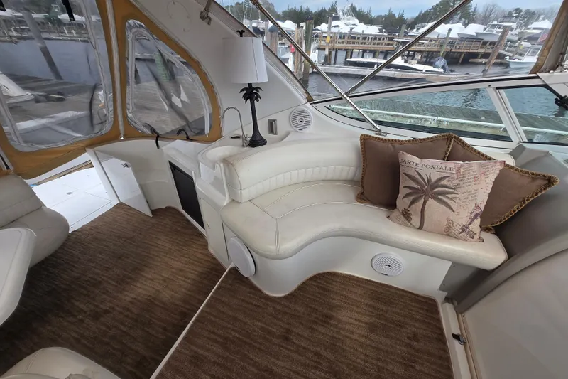 Slide: The Image of Luxurious interior of 2002 Cruisers Yachts 3372 Express with plush seating and nautical decor. - 10