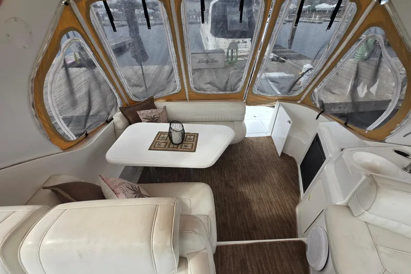 Slide: The Image of Interior of 2002 Cruisers Yachts 3372 Express with cozy seating and table. - 11