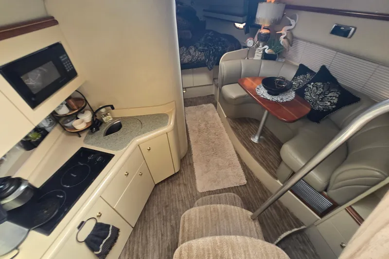 Slide: The Image of Interior of 2002 Cruisers Yachts 3372 Express with kitchen and cozy seating area. - 18