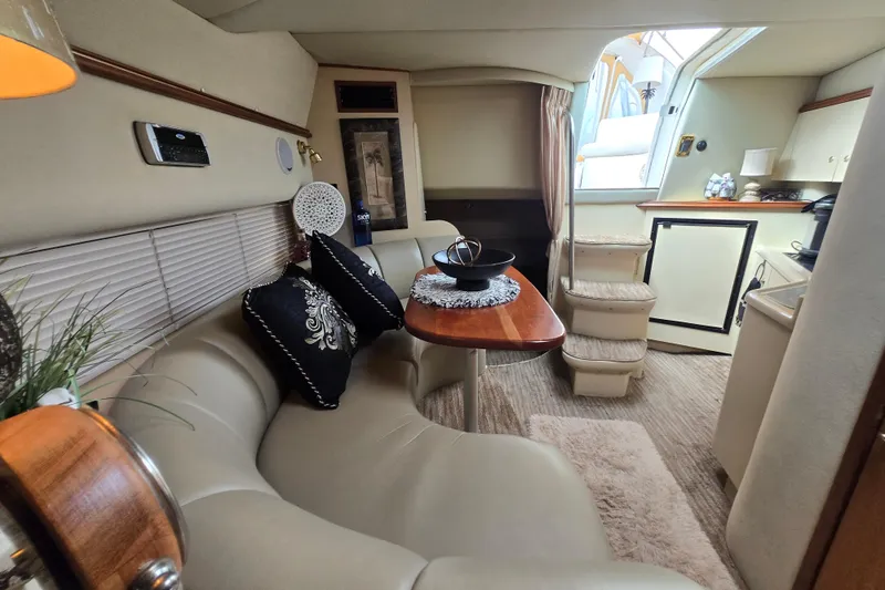 Slide: The Image of Luxurious interior of 2002 Cruisers Yachts 3372 Express with elegant seating and dining area. - 2