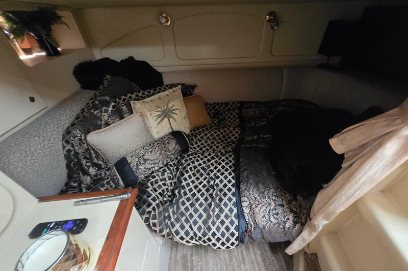 Slide: The Image of Cozy cabin interior of 2002 Cruisers Yachts 3372 Express with elegant bedding and decor. - 20