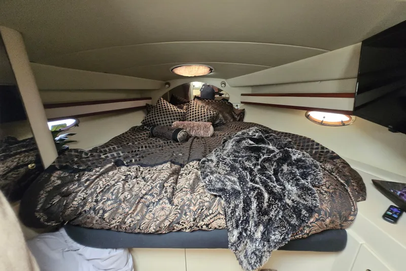 Slide: The Image of Luxurious cabin interior of 2002 Cruisers Yachts 3372 Express with plush bedding. - 21