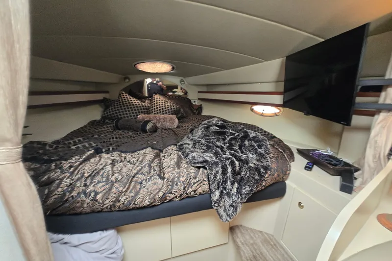 Slide: The Image of Luxurious cabin interior of 2002 Cruisers Yachts 3372 Express with plush bedding and TV. - 22