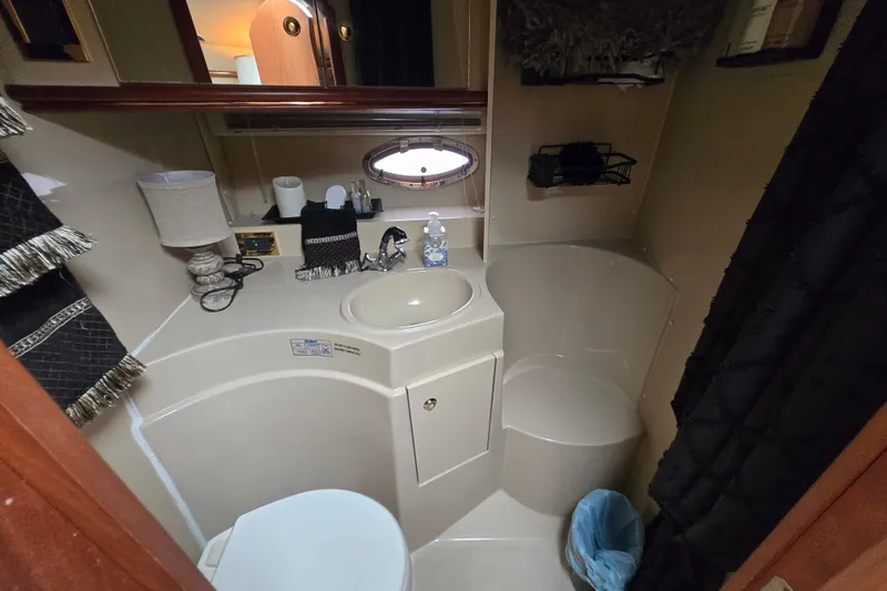 Slide: The Image of Bathroom interior of 2002 Cruisers Yachts 3372 Express, featuring sink and toilet. - 24