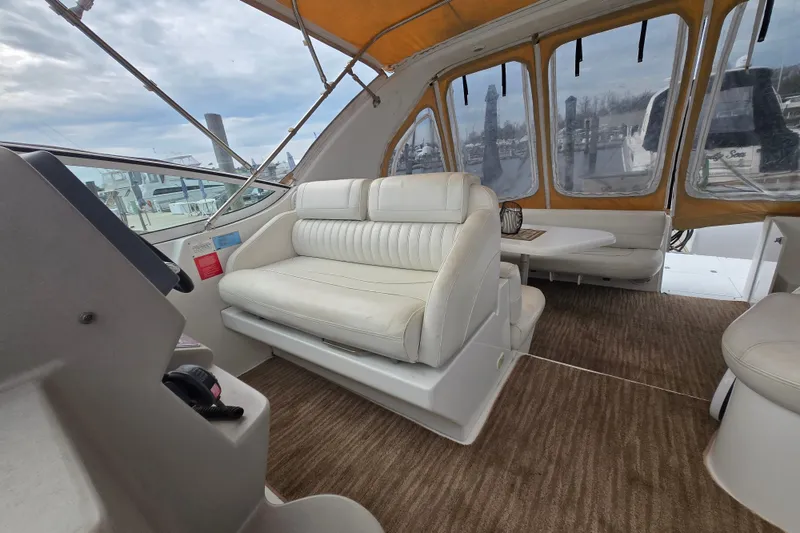 Slide: The Image of Interior of 2002 Cruisers Yachts 3372 Express with white seating and enclosed cockpit. - 27