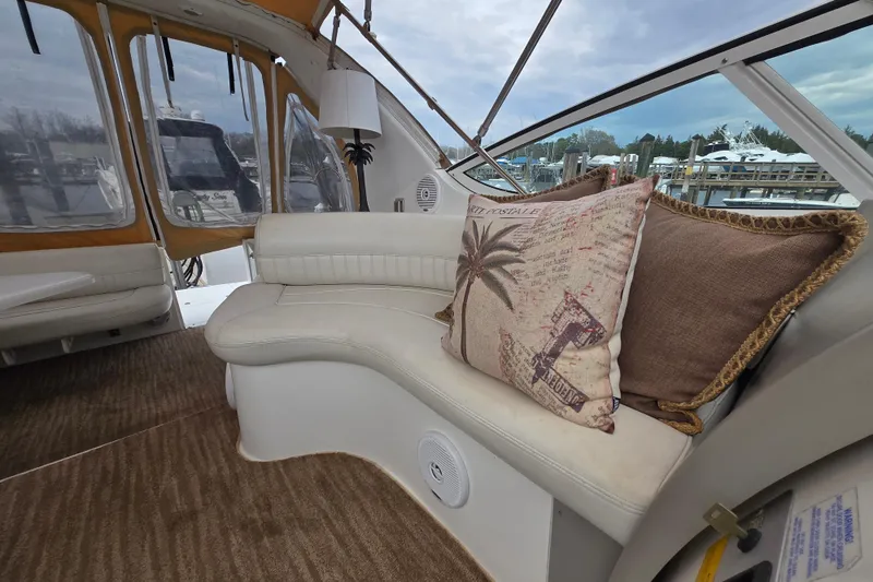 Slide: The Image of Interior of 2002 Cruisers Yachts 3372 Express with plush seating and decorative pillows. - 28