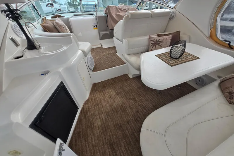 Slide: The Image of Interior of 2002 Cruisers Yachts 3372 Express, featuring plush seating and elegant decor. - 7