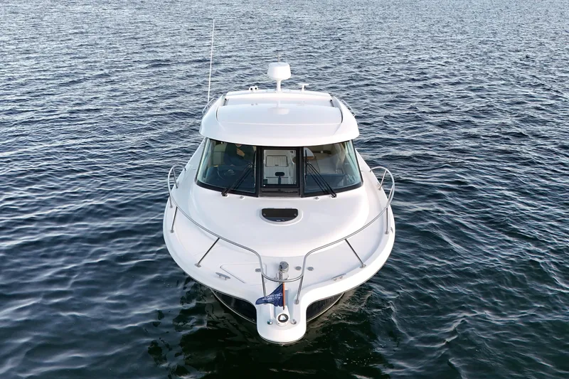 The Image of 2014 Tiara Yachts 3100 Coronet cruising on open water, front view. - 0