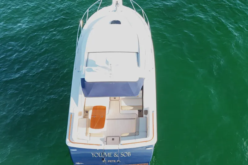 Slide: The Image of Overhead view of 2014 Tiara Yachts 3100 Coronet on clear green water. - 11