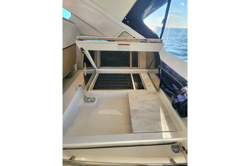 Slide: The Image of 2014 Tiara Yachts 3100 Coronet interior with sink and grill, ocean view. - 14