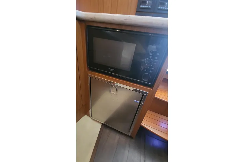 Slide: The Image of Microwave and storage area in 2014 Tiara Yachts 3100 Coronet interior. - 16