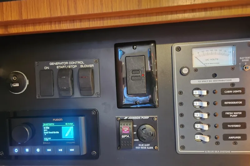 Slide: The Image of Control panel of a 2014 Tiara Yachts 3100 Coronet, featuring generator and electrical switches. - 19