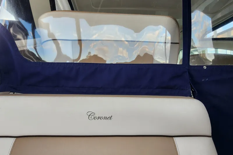 Slide: The Image of 2014 Tiara Yachts 3100 Coronet interior with "Coronet" logo on beige seating. - 20