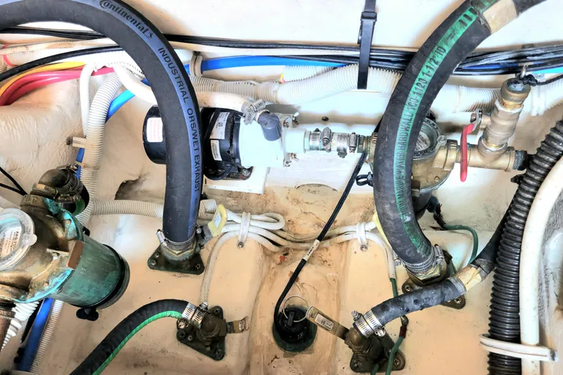 Slide: The Image of Engine compartment of a 2014 Tiara Yachts 3100 Coronet, showcasing hoses and mechanical components. - 25