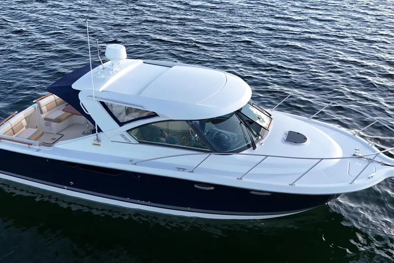 Slide: The Image of 2014 Tiara Yachts 3100 Coronet cruising on open water, showcasing sleek design and luxury features. - 4