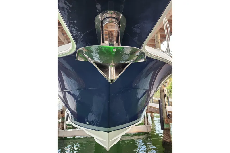 Slide: The Image of 2014 Tiara Yachts 3100 Coronet bow view, docked, with green navigation light. - 8