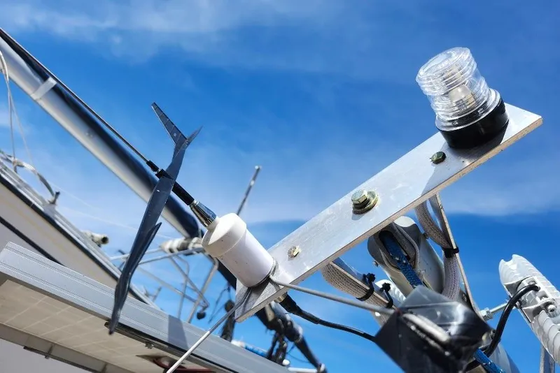 Slide: The Image of Sailboat rigging and equipment on a Precision 165, 1996 model, under clear blue sky. - 10