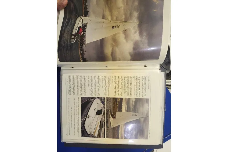 Slide: The Image of Open book displaying a Precision 165 sailboat from 1996, featuring images and descriptive text. - 18