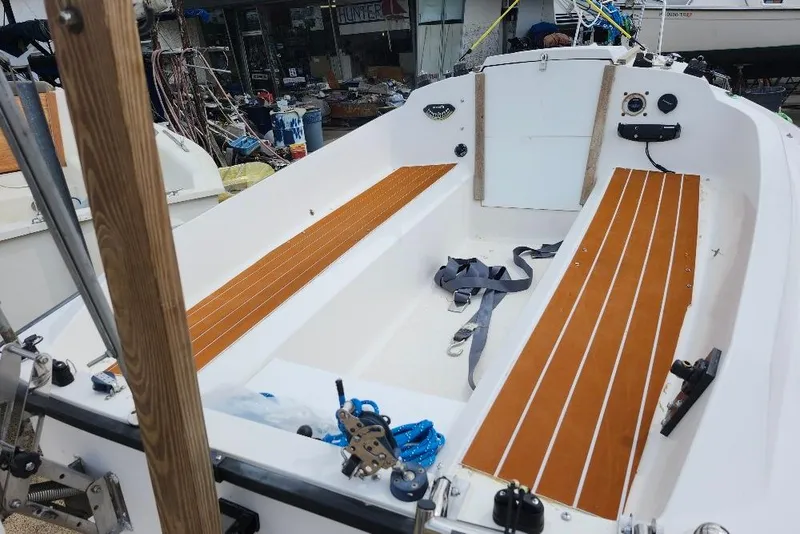 Slide: The Image of Interior of a 1996 Precision 165 sailboat with wooden seating and nautical equipment. - 4