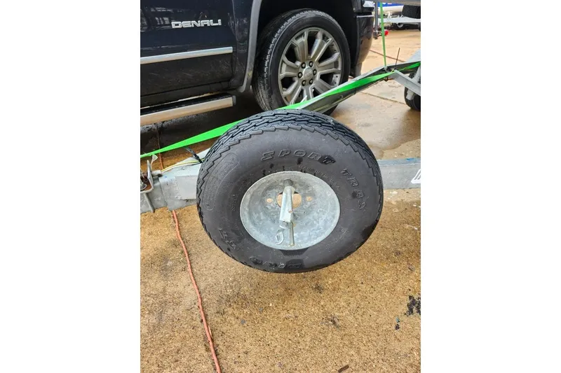 Slide: The Image of Trailer wheel on Precision 165, 1996 model, parked beside a vehicle. - 8